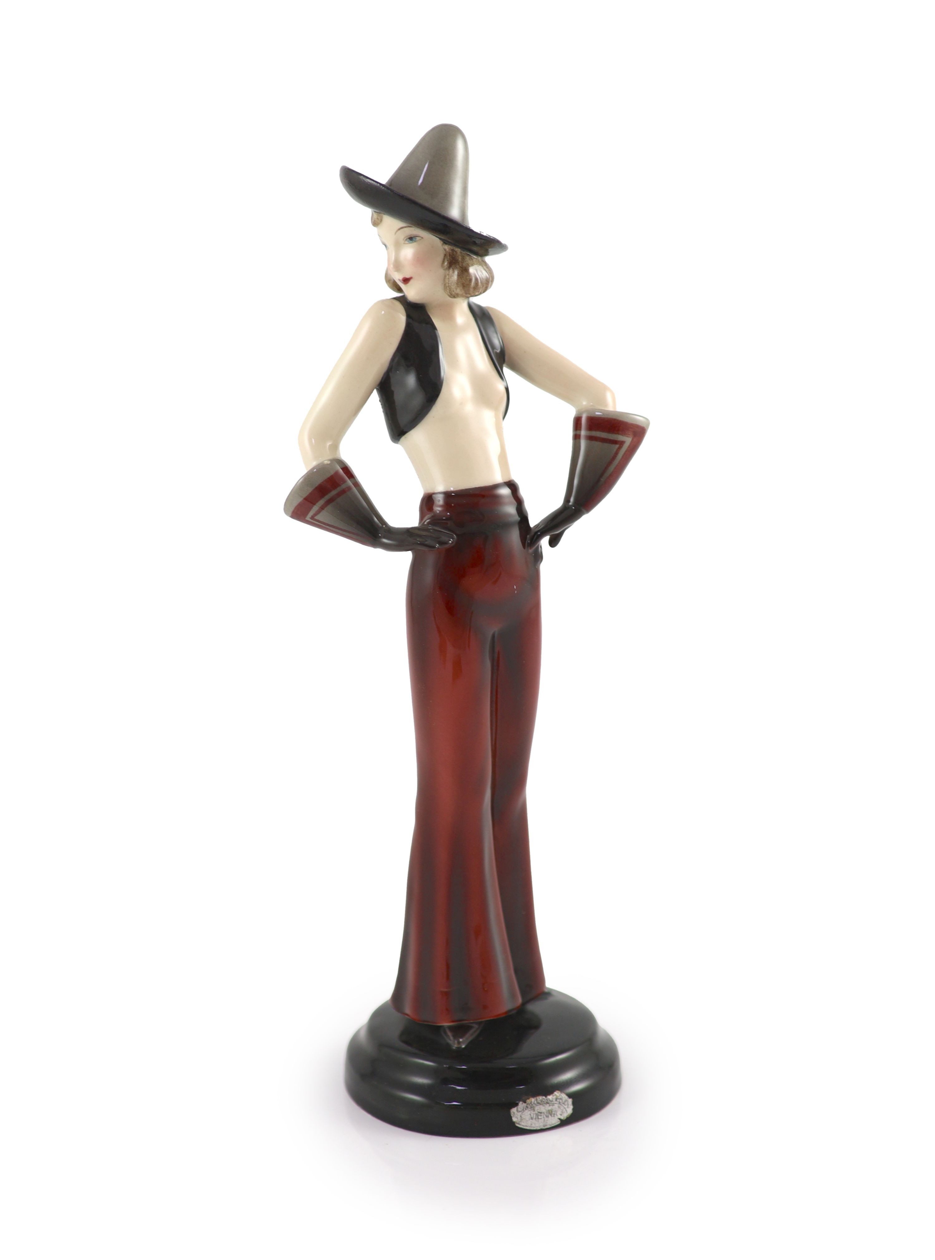 Stefan Dakon for Goldscheider, an Art Deco pottery figure of a girl wearing a Sombrero, c.1935, 30.5cm high